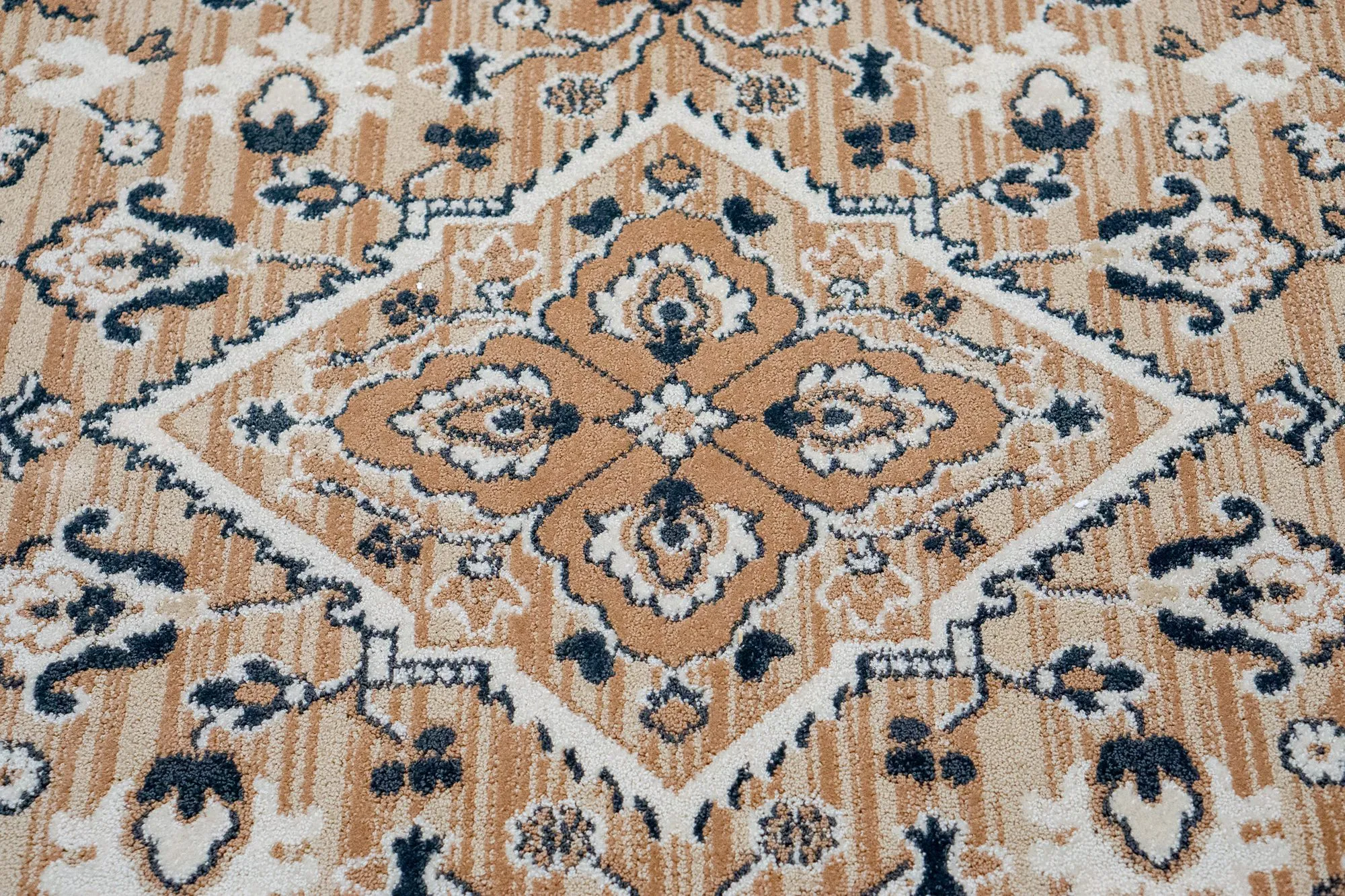 Senior living interior detail: carpet with a tan and navy medallion pattern