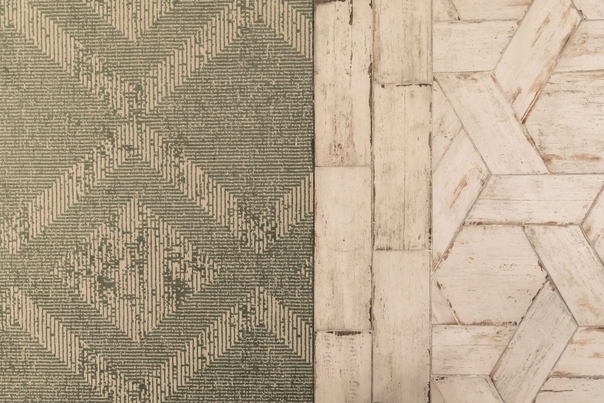 Senior living interior detail: green patterned carpet meeting whitewashed wood-look tile laid in a geometric pattern