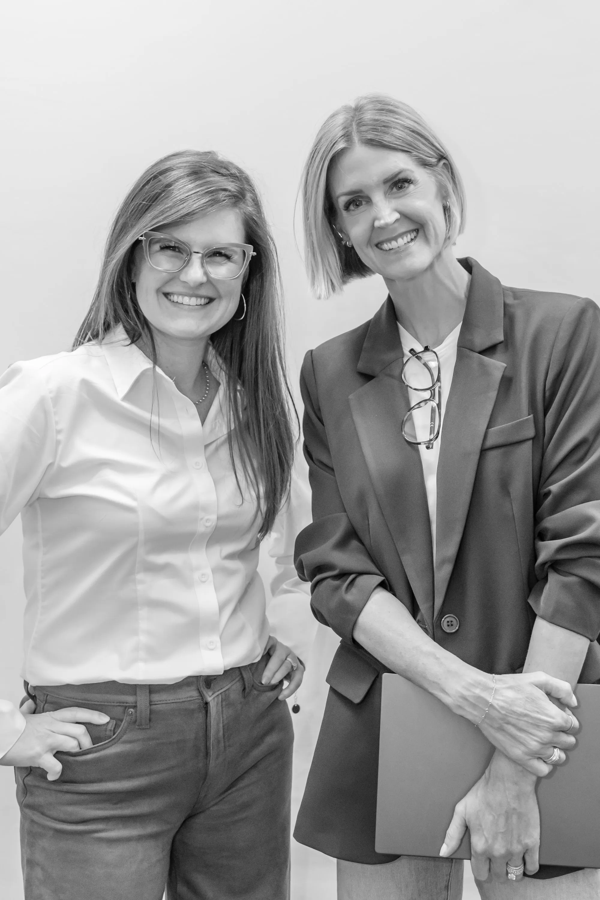 Two members of the Banko Design business development team standing in the studio, in black and white