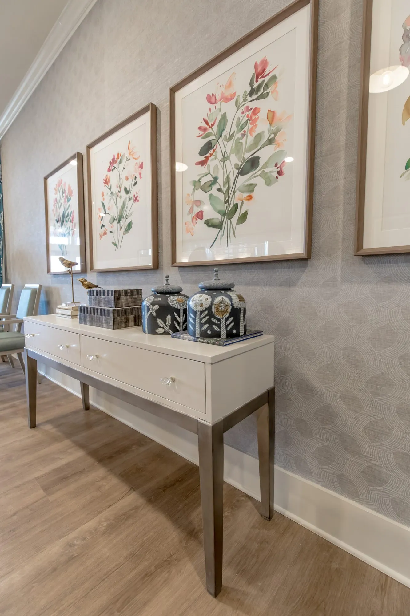 Senior living interior detail: blue ceramic jars below botanical watercolours, interior design by Banko Design at Everlan of Hixson, Hixson, Tennessee