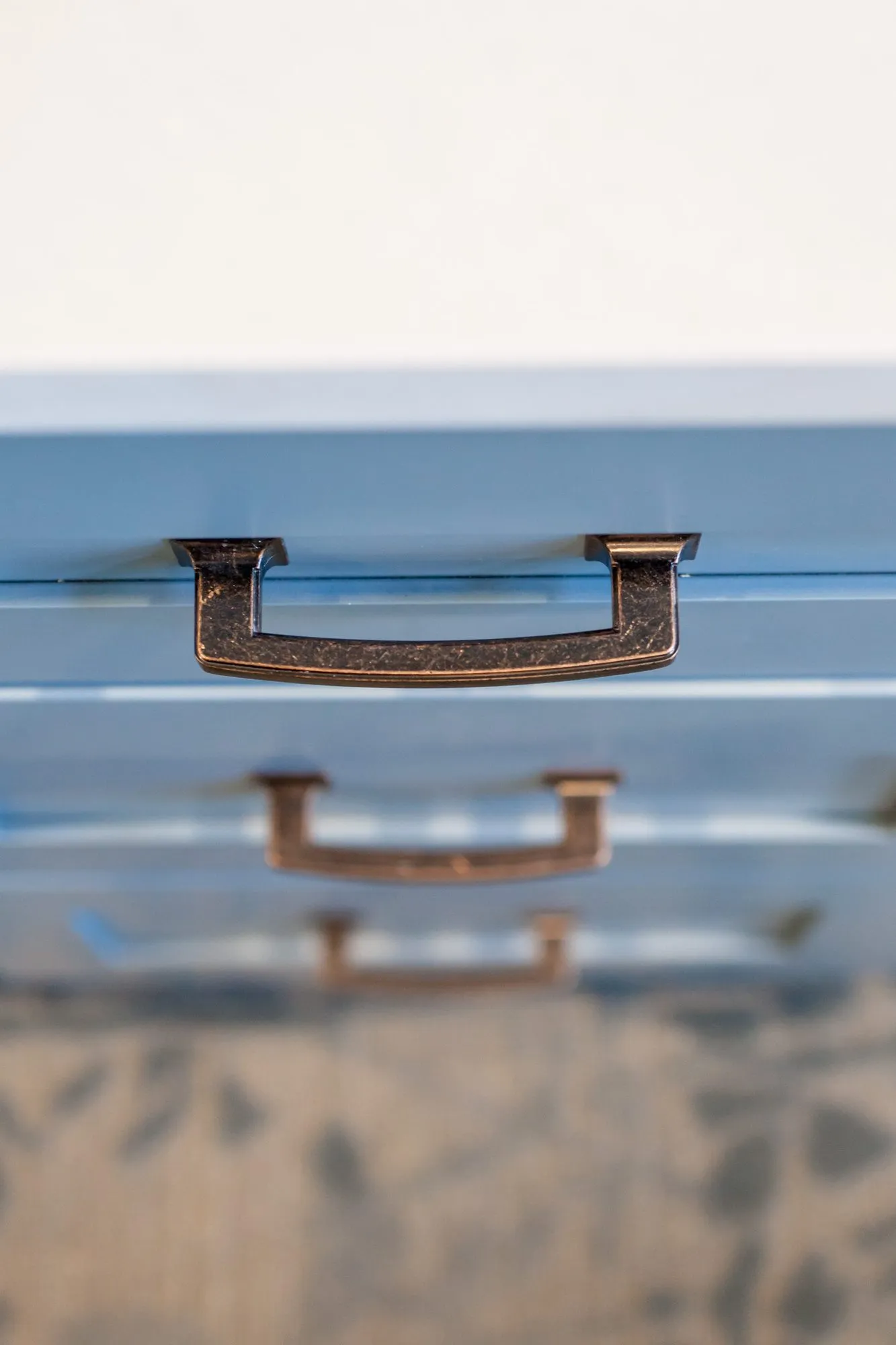 Senior living interior detail: bronze drawer pulls on blue painted drawers
