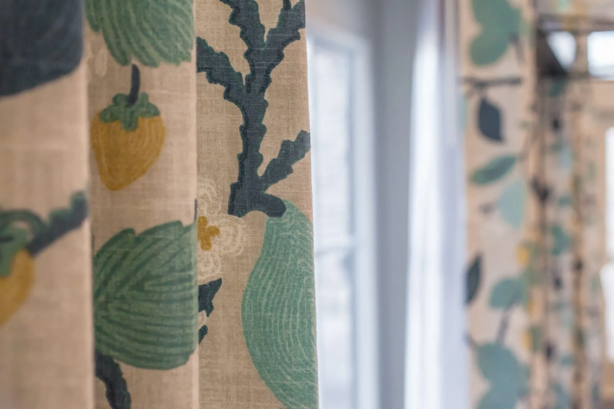 Senior living interior detail: curtains printed with green leaves and yellow fruit