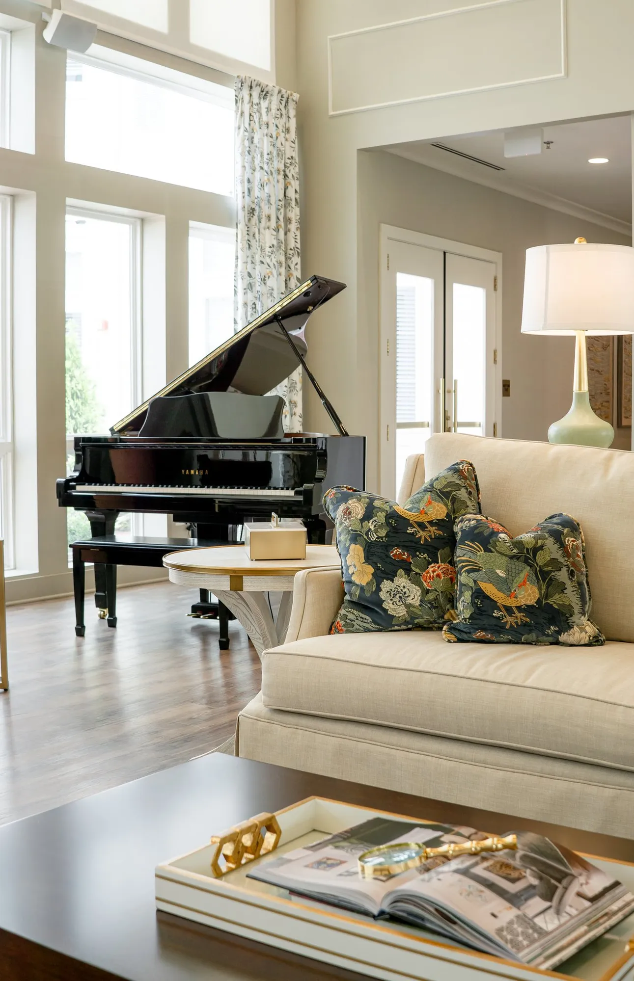 Senior living great room with a cream sofa beside a black grand piano, interior design by Banko Design at Varenita of West Cobb, Acworth, Georgia