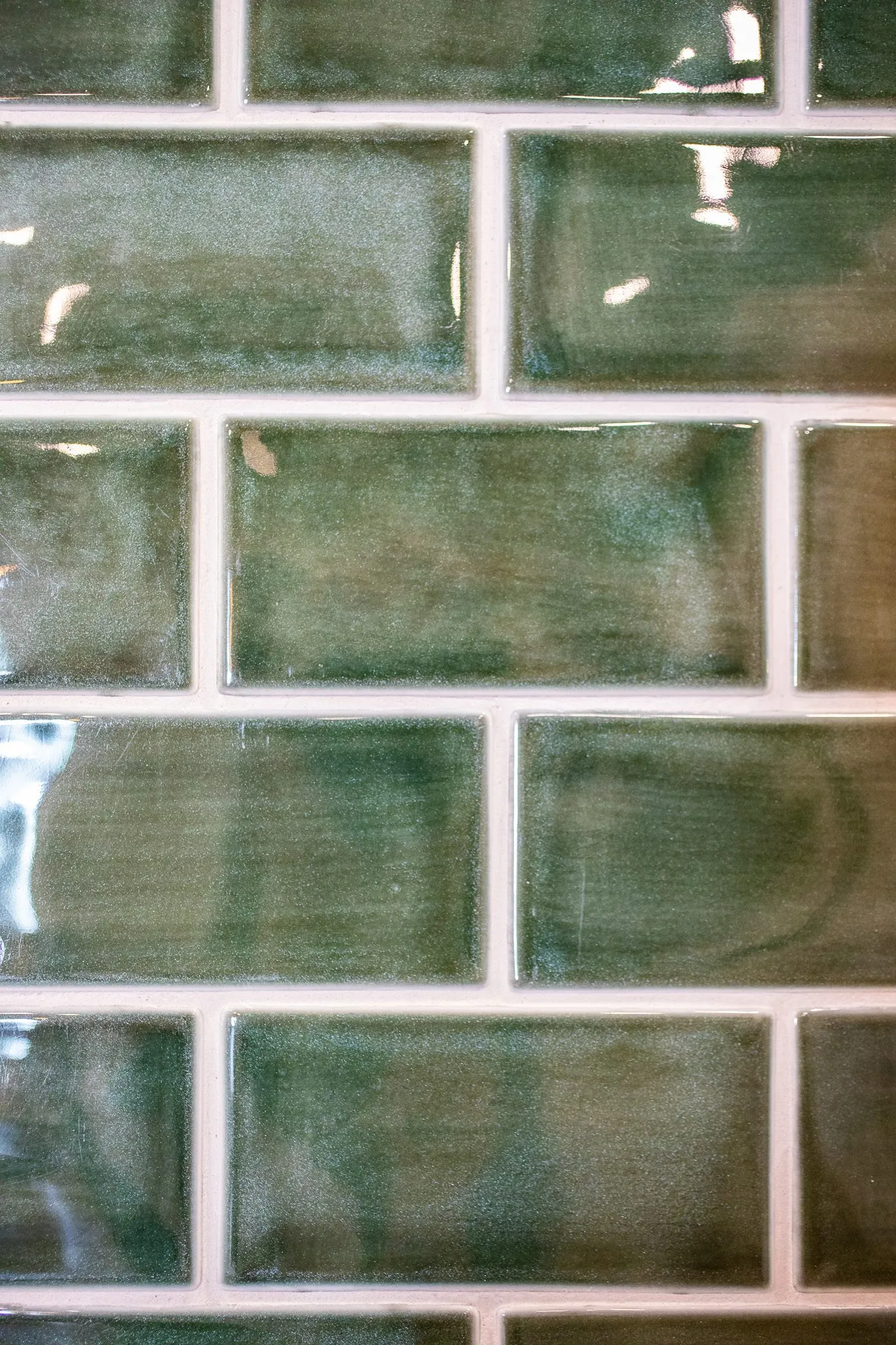 Multifamily interior detail: glossy green handmade subway tile
