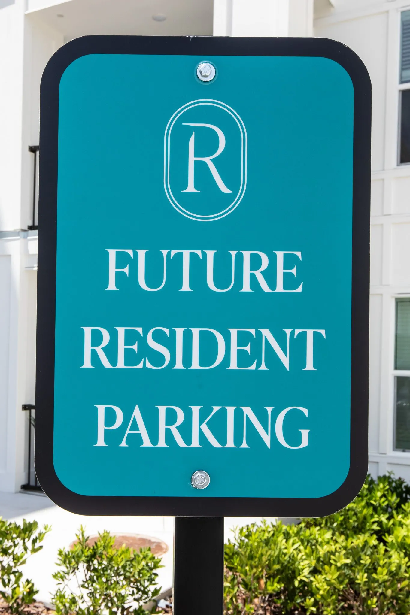 Multifamily community signage: teal parking sign reading Future Resident Parking below a monogram