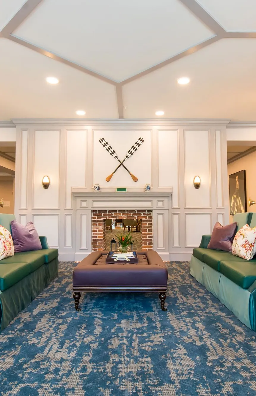 Senior living music room with teal high back sofas and horn floor lamps, interior design by Banko Design at The Phoenix at Hammond, Hammond, Louisiana