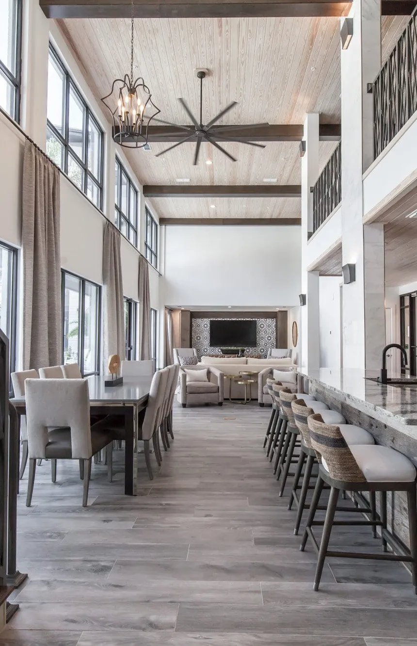 Multifamily amenity clubhouse with a reclaimed wood bar under a plank vaulted ceiling, interior design by Banko Design at The Jaxon, Jacksonville, Florida