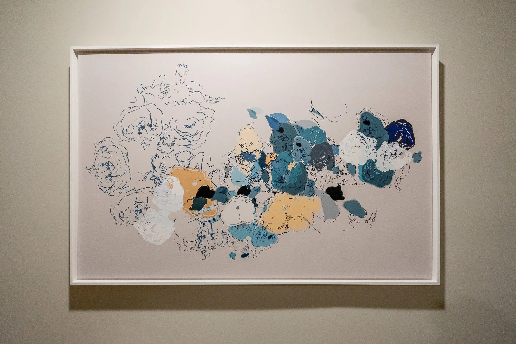 Multifamily interior detail: framed abstract floral artwork of blue, cream and gold blooms with loose ink outlines