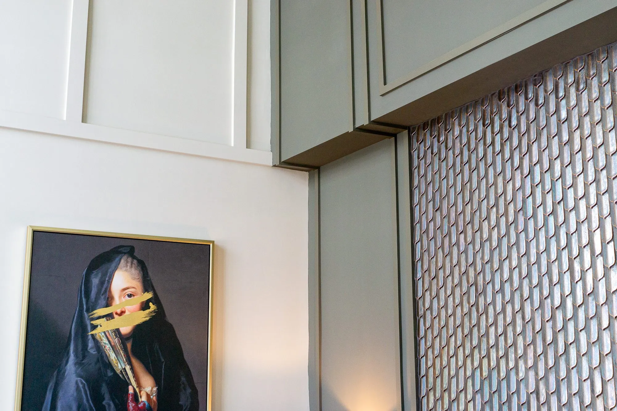 Multifamily amenity lobby lounge corner where the veiled portrait meets a shimmering feather tile panel in grey panelling