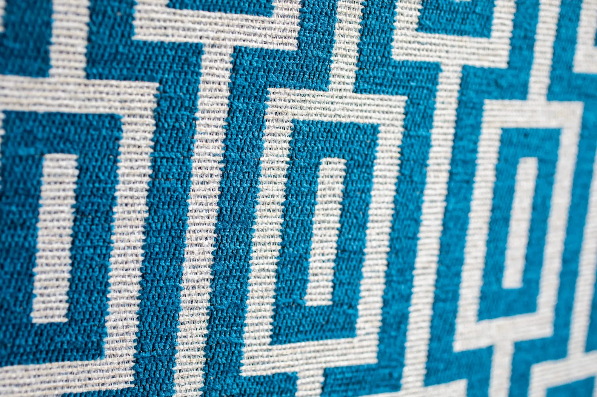 Senior living interior detail: teal and cream Greek key upholstery fabric