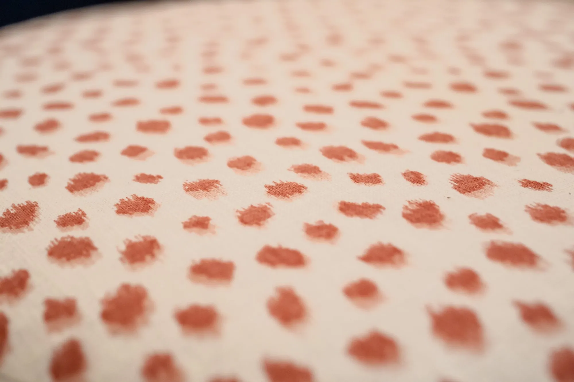 Senior living interior detail: cream fabric with coral dots