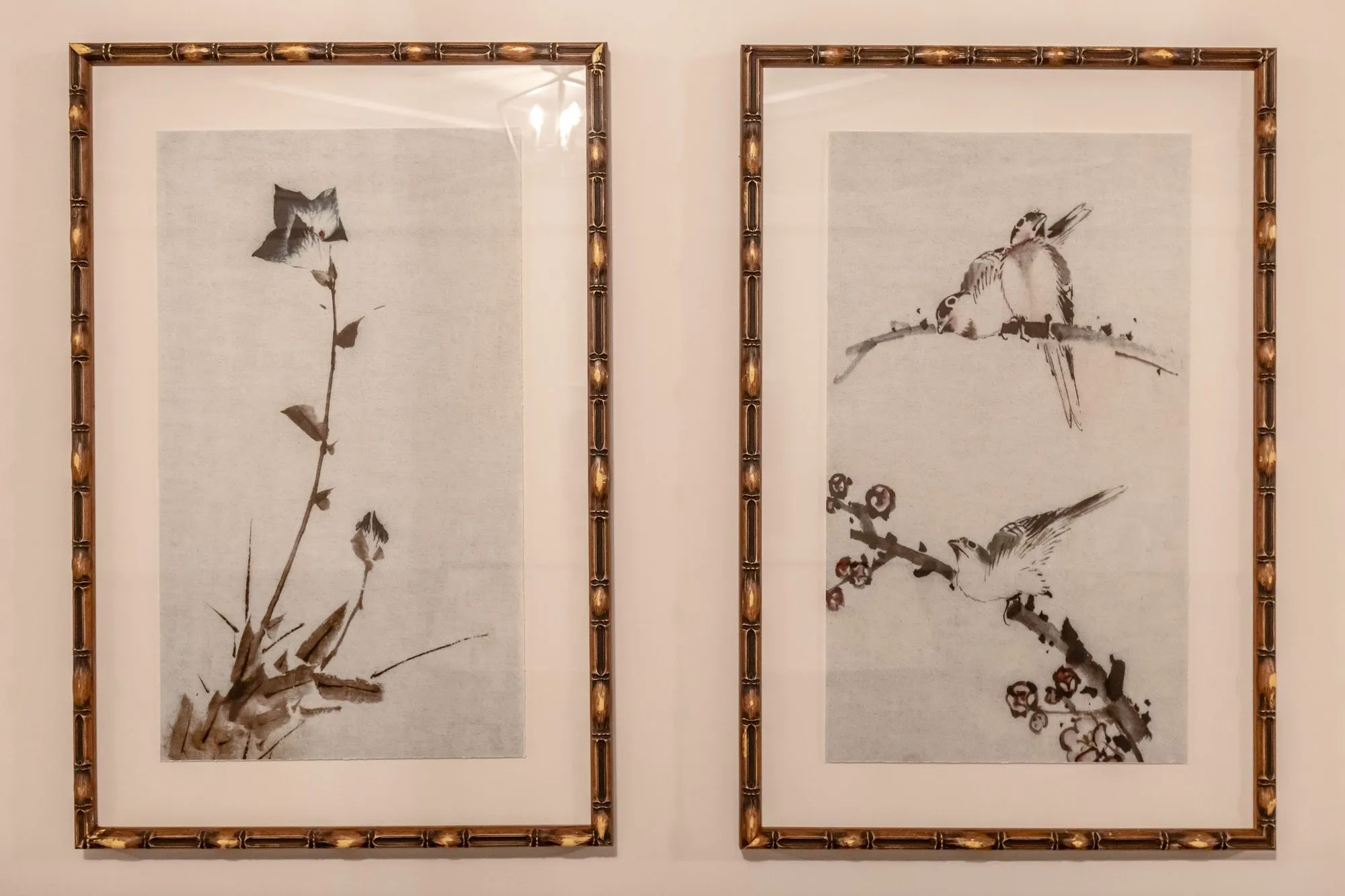Senior living interior detail: two bamboo framed ink prints of birds and blossoms
