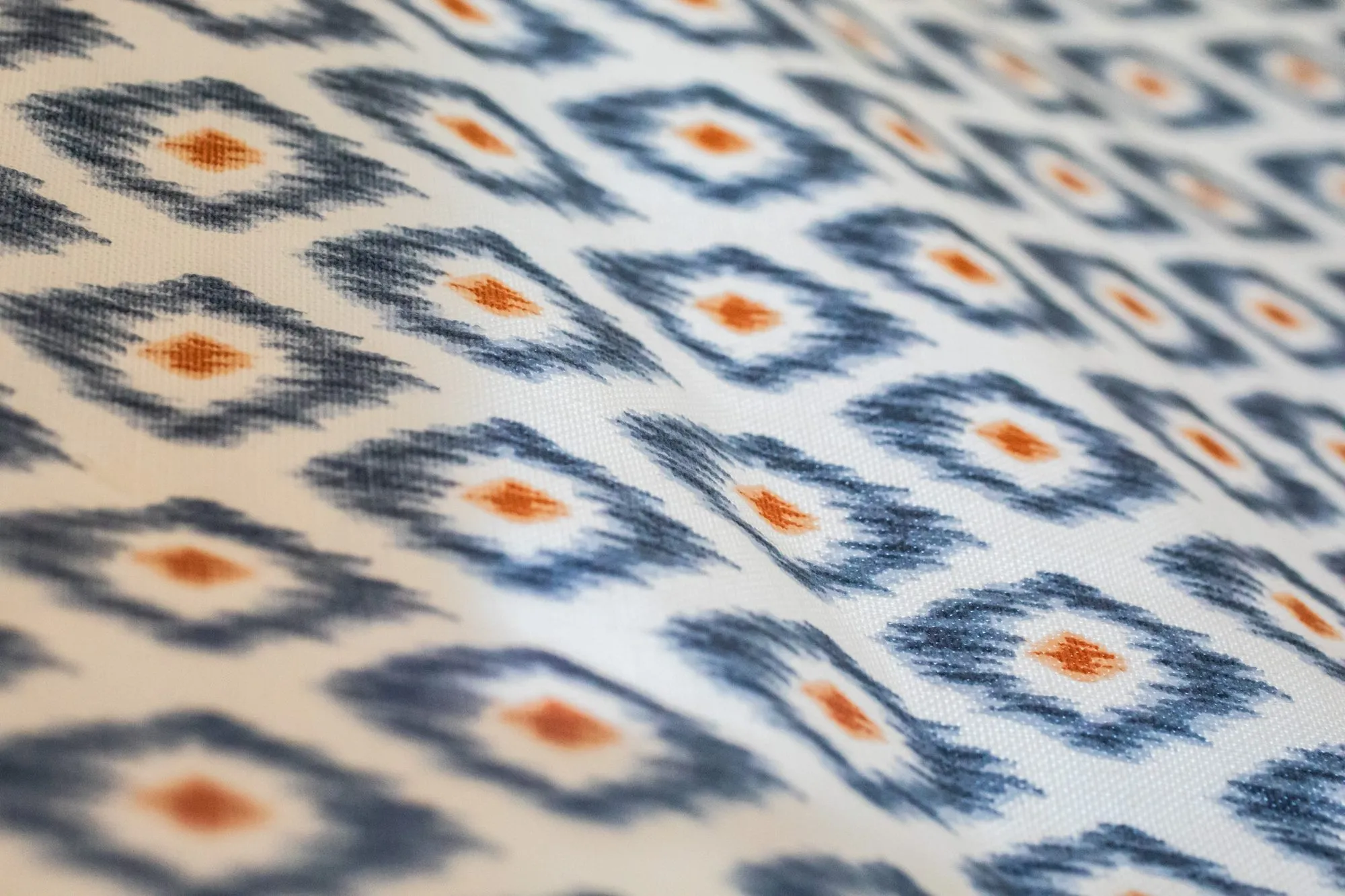 Senior living interior detail: ikat diamond pattern fabric in navy and orange