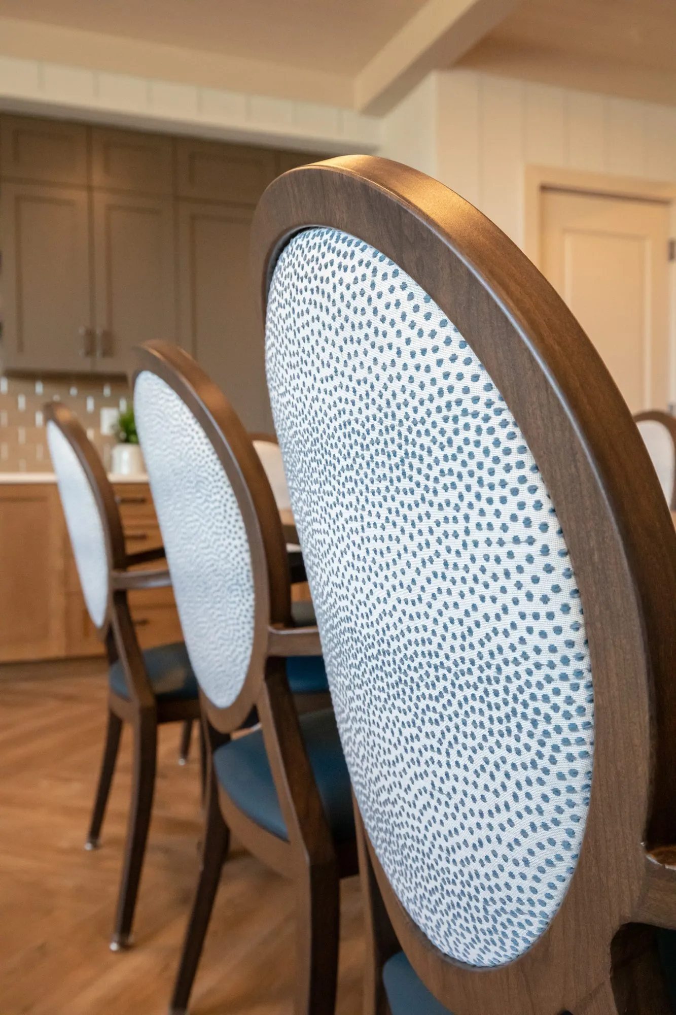 Senior living interior detail: oval back dining chairs upholstered in blue dot fabric