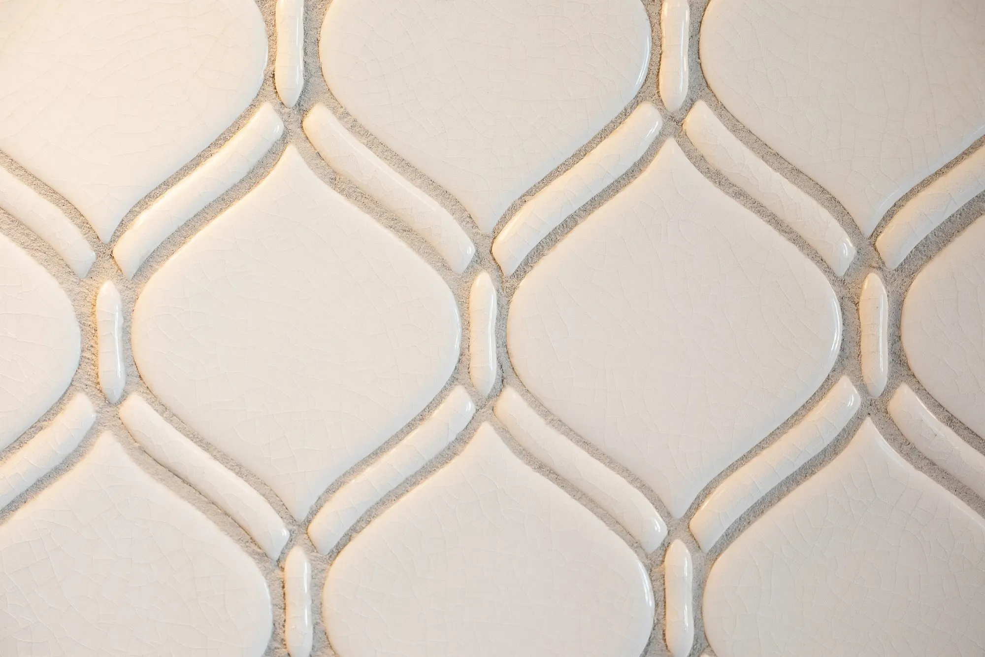 Senior living interior detail: glossy white ogee relief tile