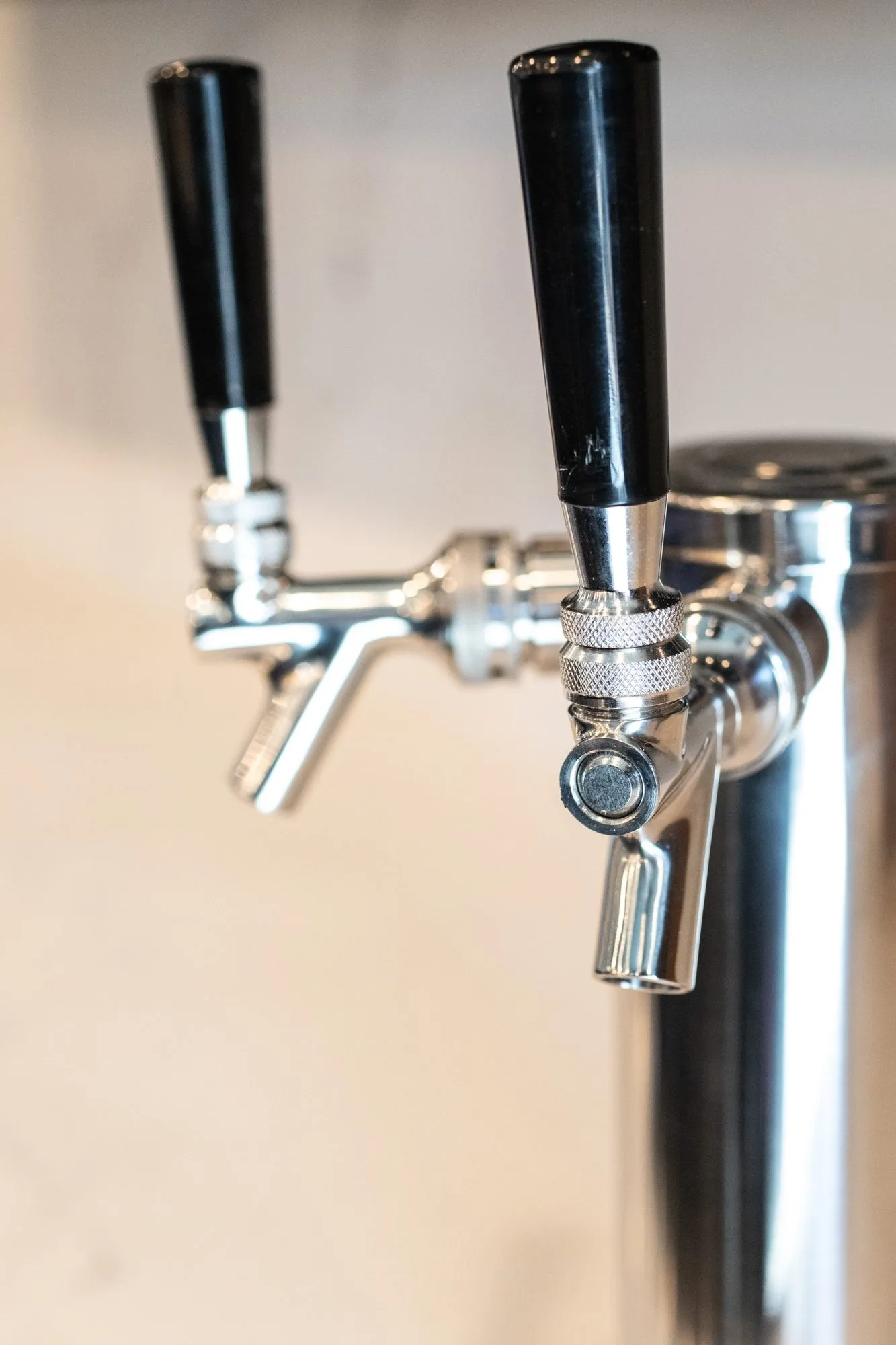 Senior living interior detail: chrome beer taps with black handles