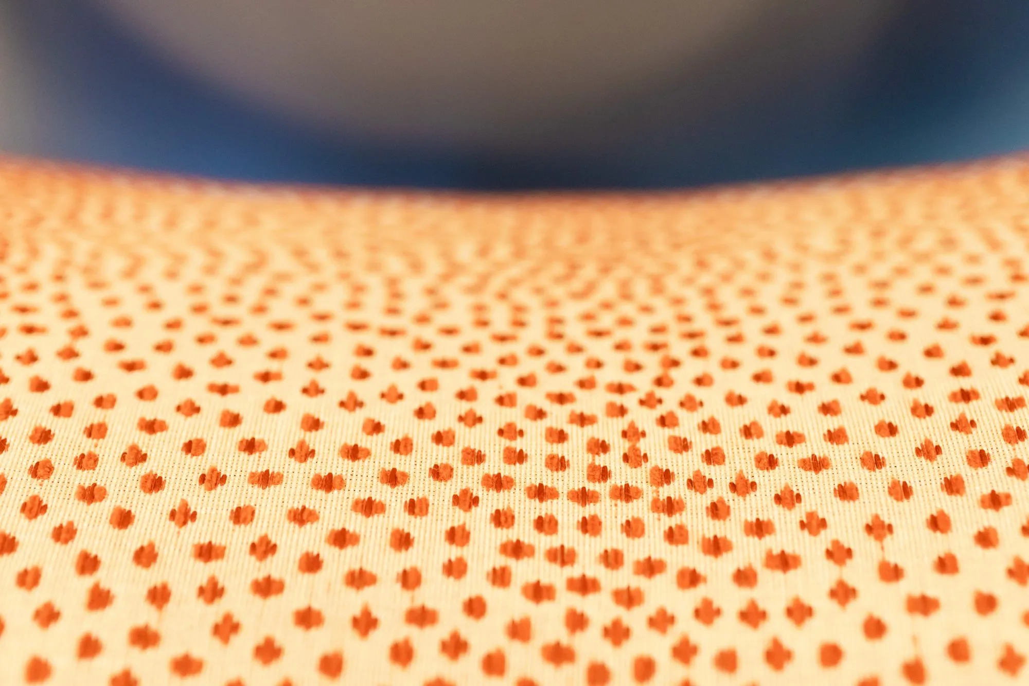 Senior living interior detail: cream upholstery with small coral dots