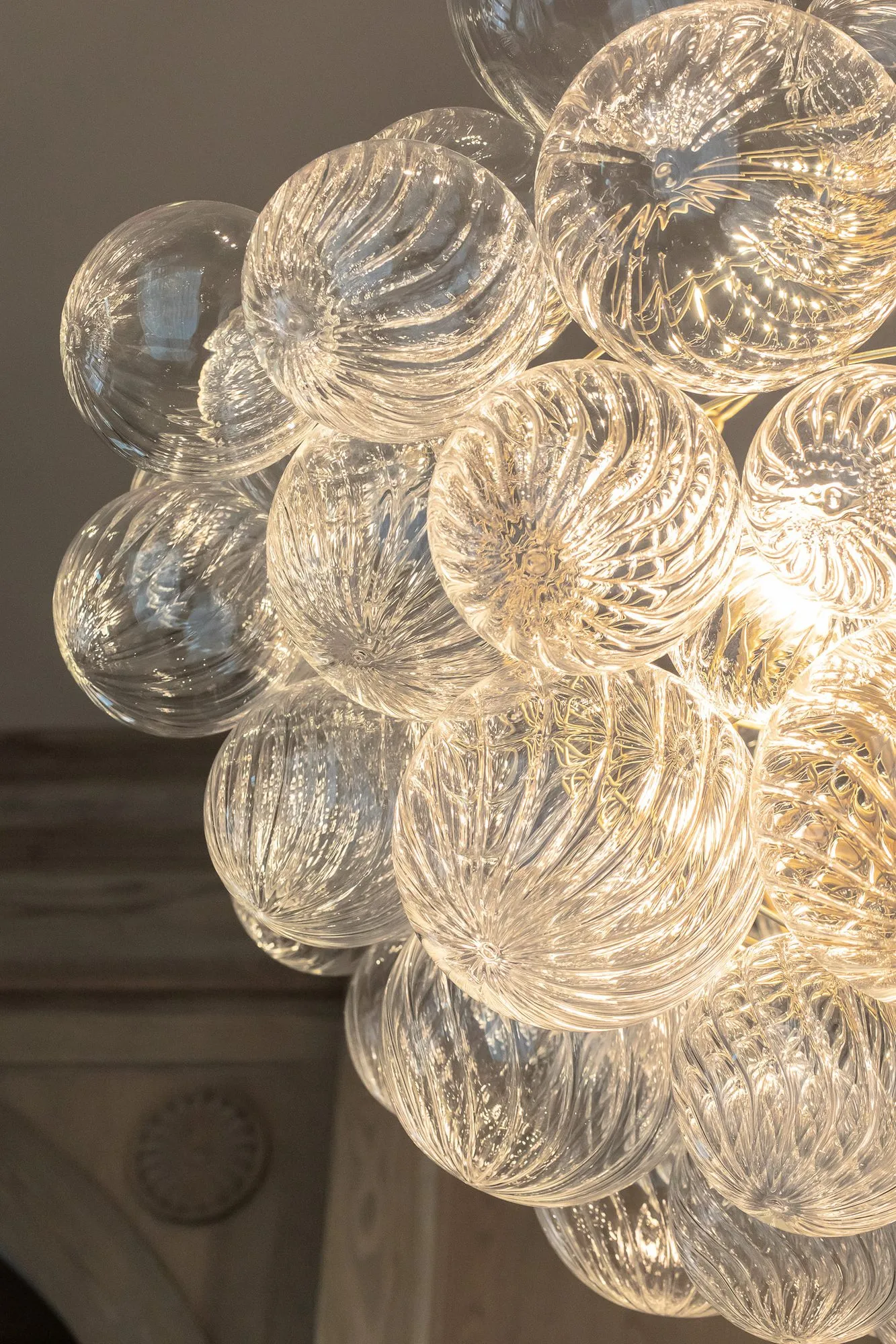 Private club interior detail: chandelier of clear swirled glass globes