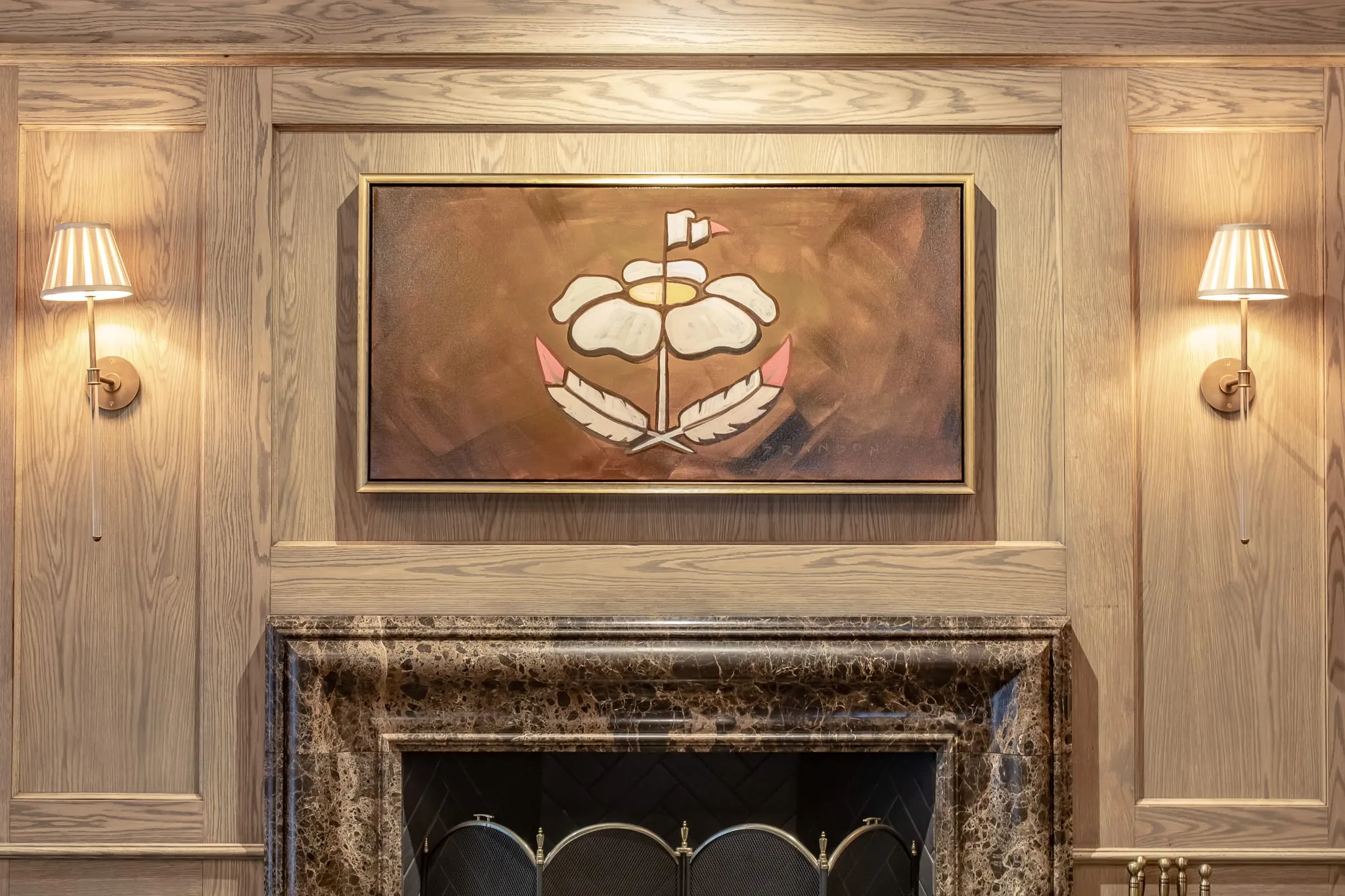 Private club interior detail: commissioned Cherokee rose crest painting above the marble fireplace between pleated sconces