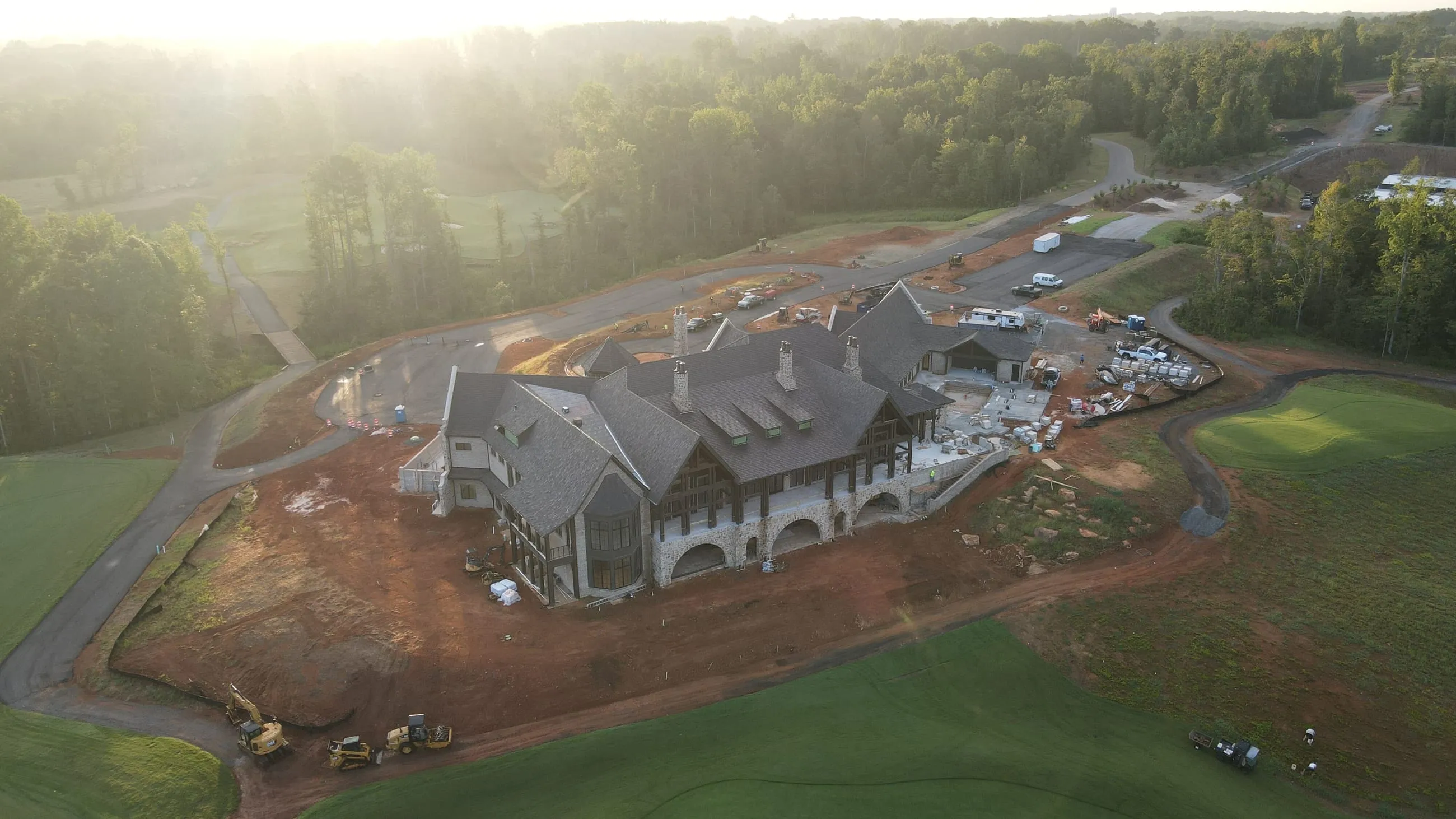Private club clubhouse under construction: long aerial view of the rear across the course