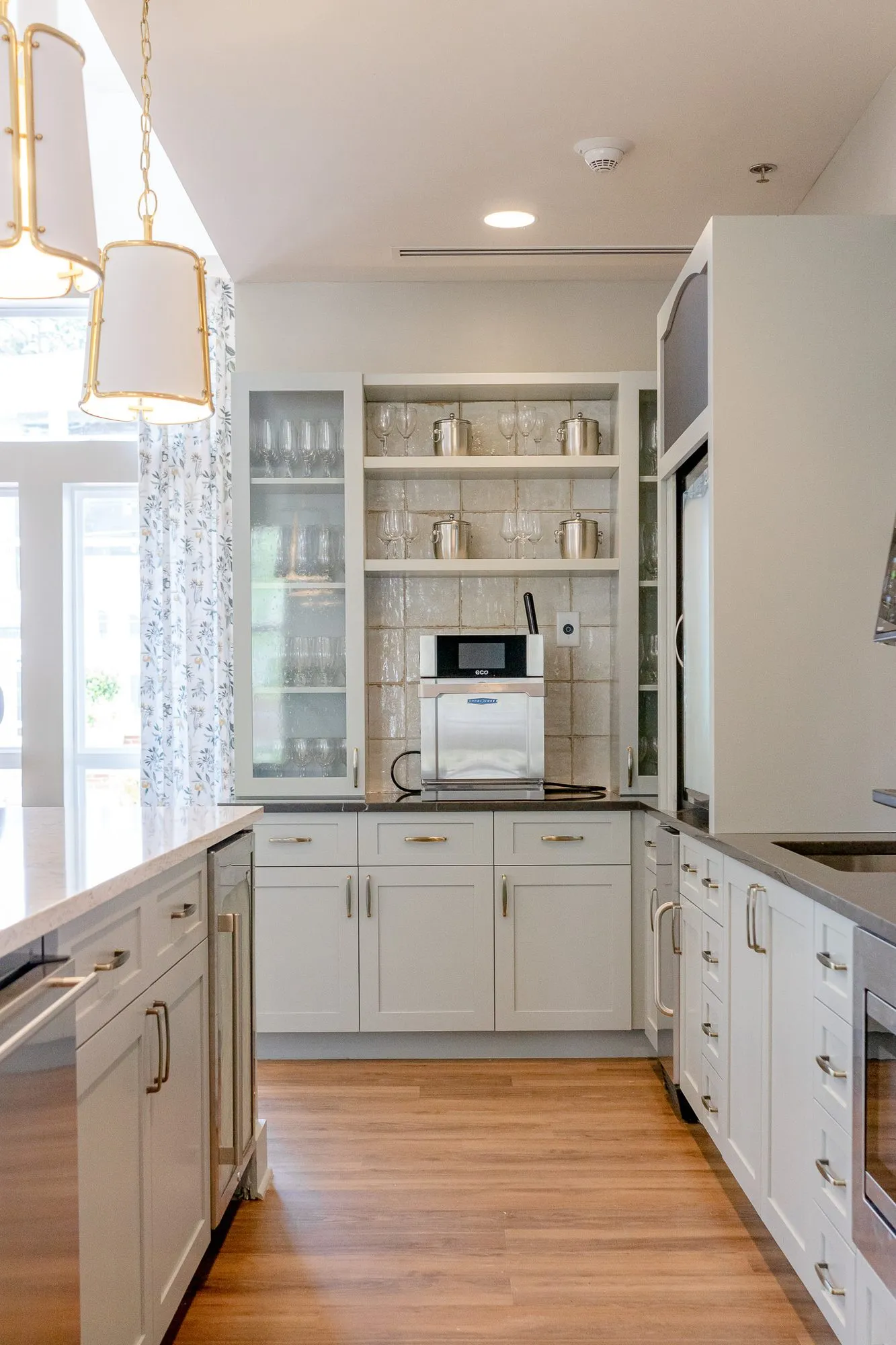 Senior living serving pantry with white shaker cabinets and a coffee machine, interior design by Banko Design at Varenita of West Cobb, Acworth, Georgia