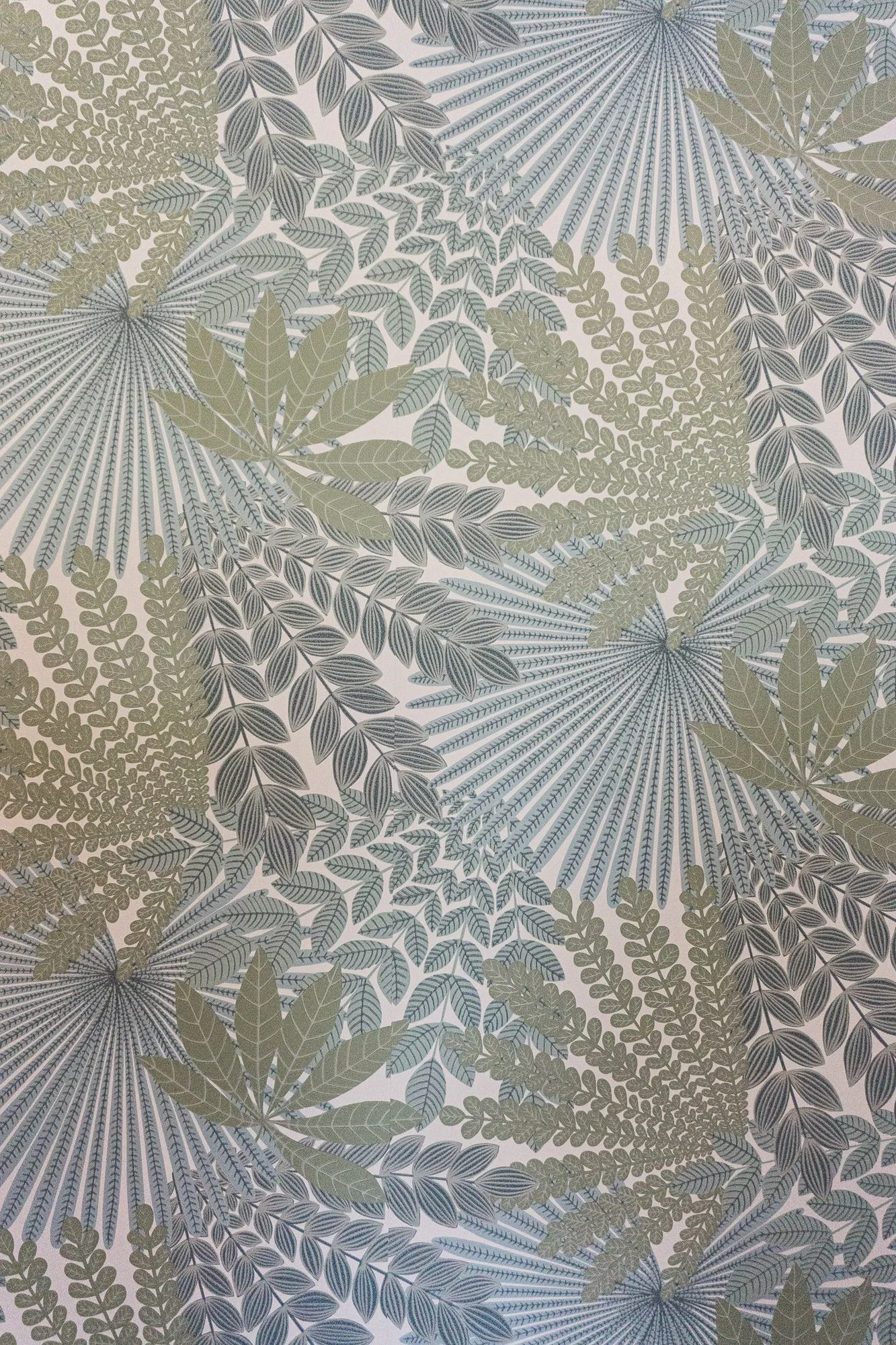 Senior living interior detail: wallpaper patterned with sage and grey palm fronds and ferns